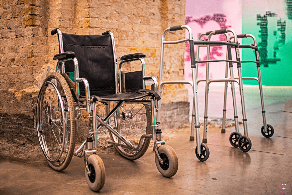 Manual wheelchair and walkers against a brick wall.