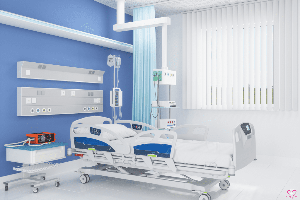 Modern hospital room with medical equipment and hospital beds.