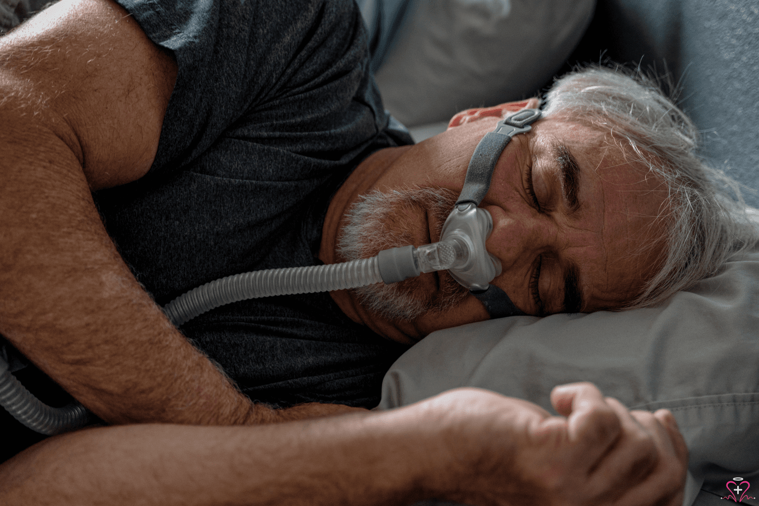 Man sleeping with a CPAP machine mask.