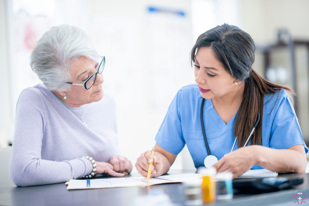 Medication Reviews - A nurse in blue scrubs reviewing a medication plan with an elderly woman wearing glasses and a light purple sweater.