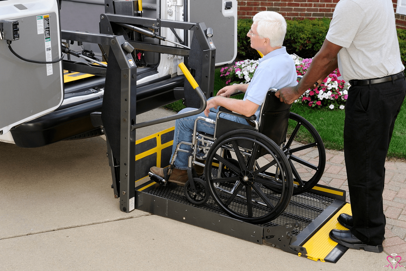 Non-Emergency Medical Transportation - Person in a wheelchair being assisted onto a vehicle with a lift