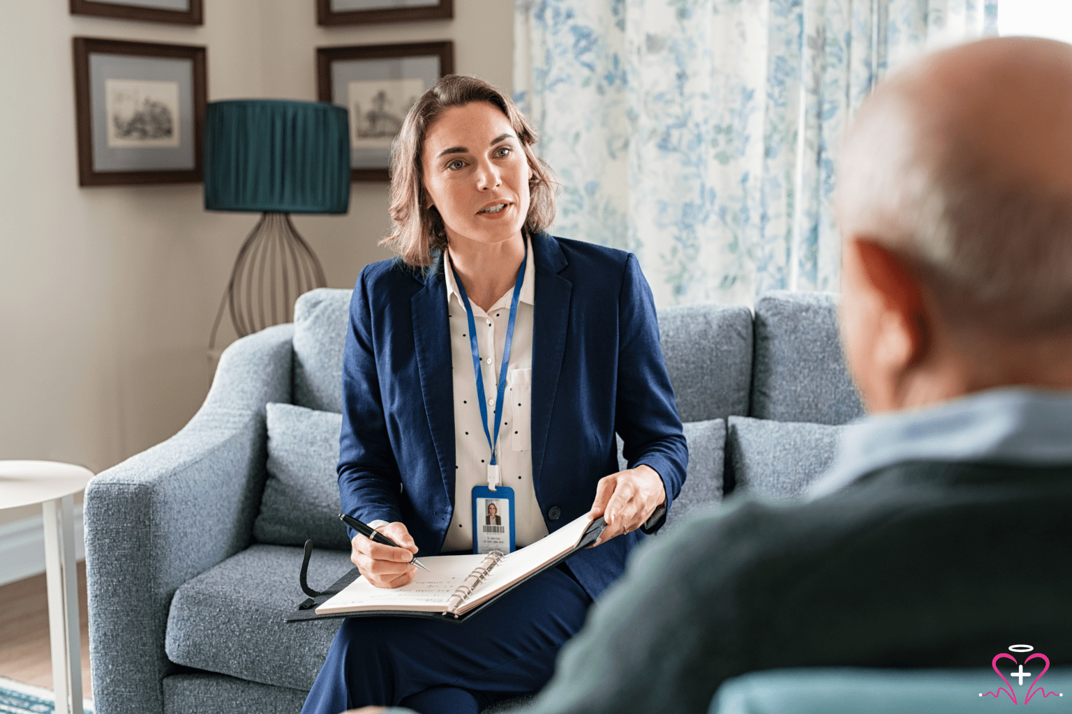 Medical social worker assisting a senior patient with healthcare services.