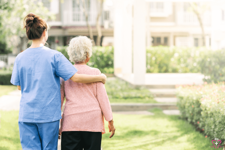 Home health nurse walking with a senior patient.