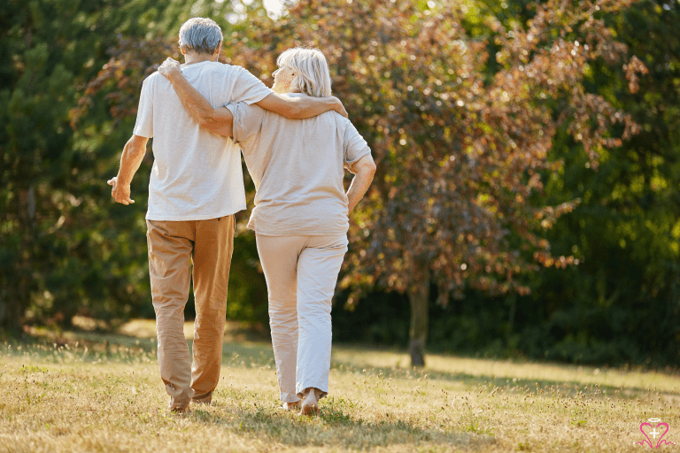 Senior couple walking in the park, looking stress-free