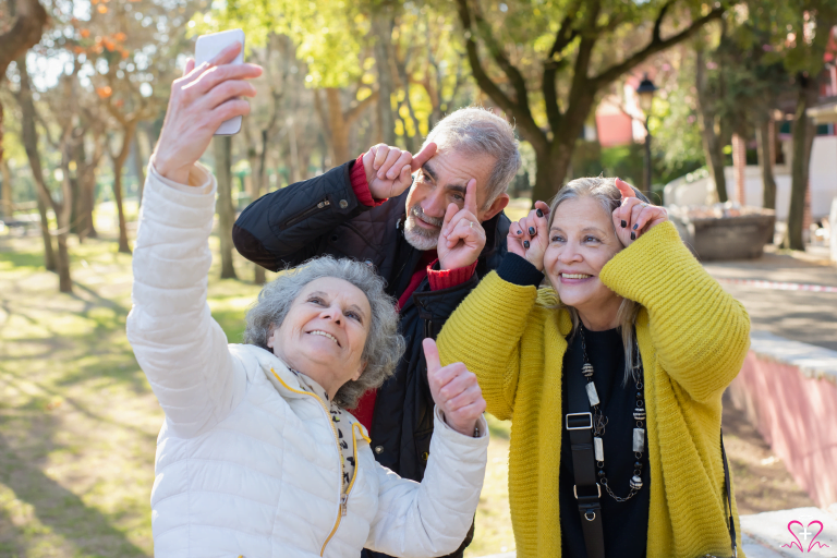 Seniors taking a selfie with a free phone provided by All Seniors Foundation.