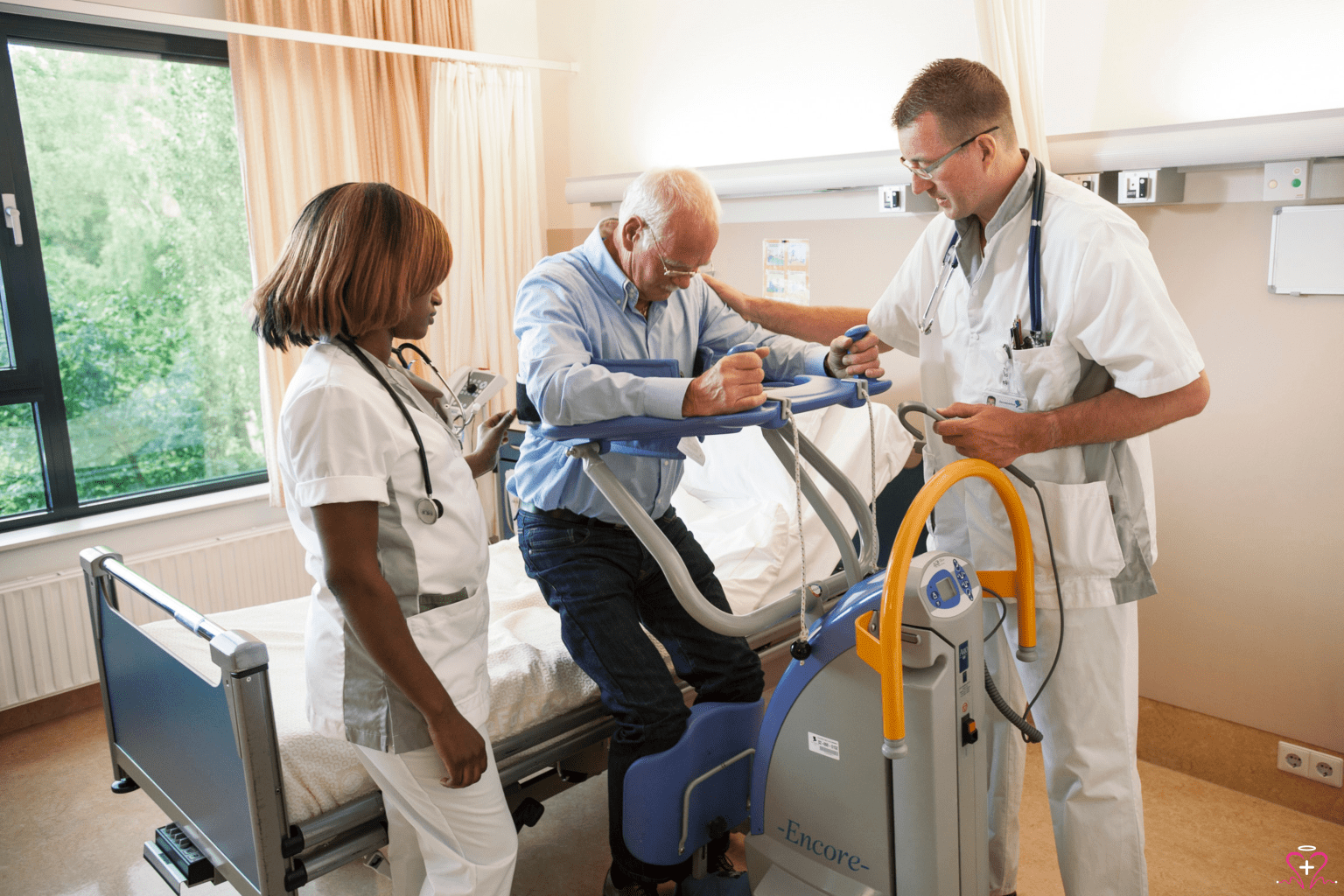 Healthcare professionals assisting a patient with a patient lift.