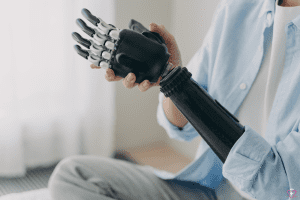 Person adjusting a prosthetic arm device.