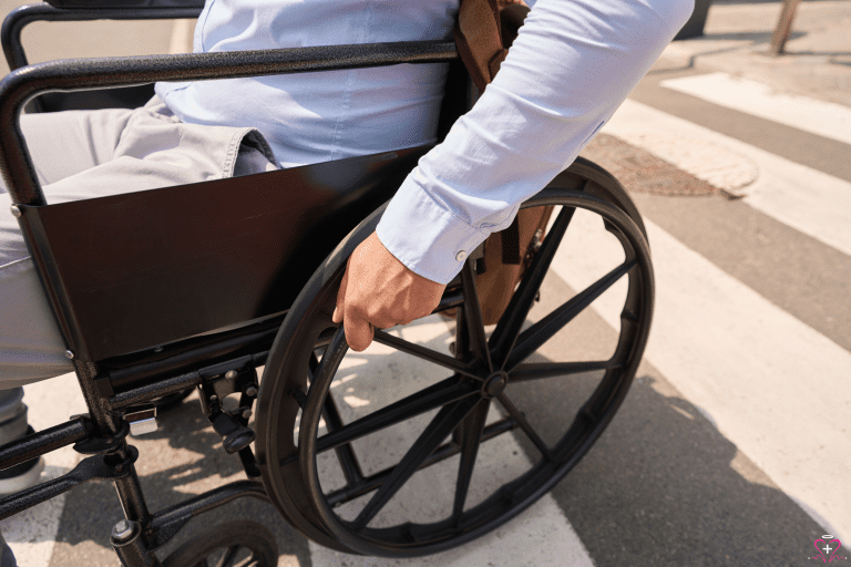 Close-up of a person using a manual wheelchair.