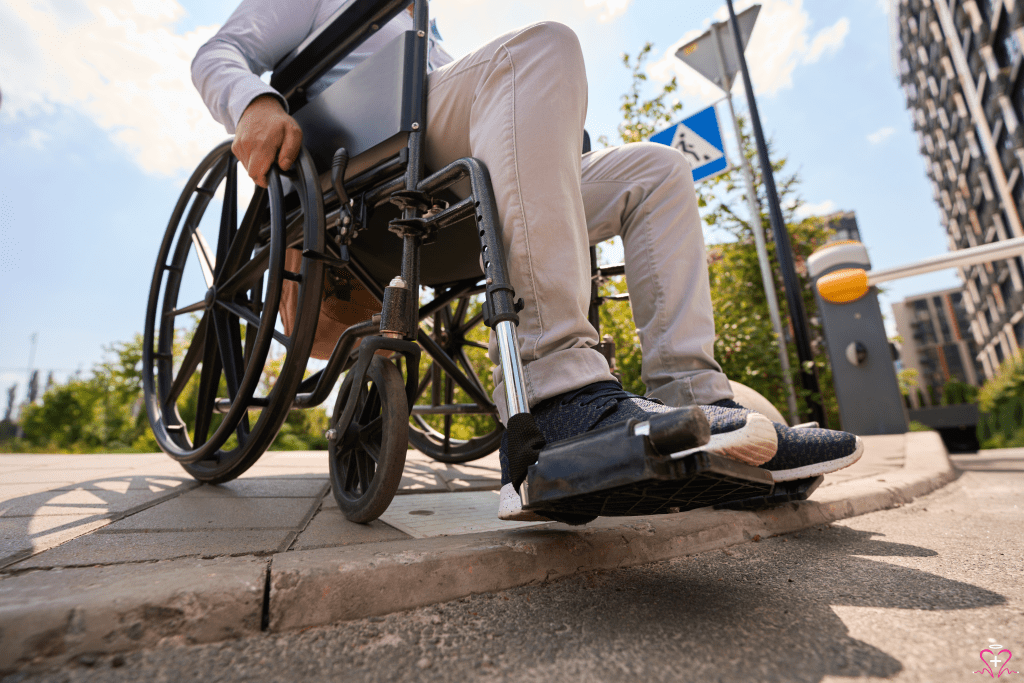 Person in a manual wheelchair navigating a curb.