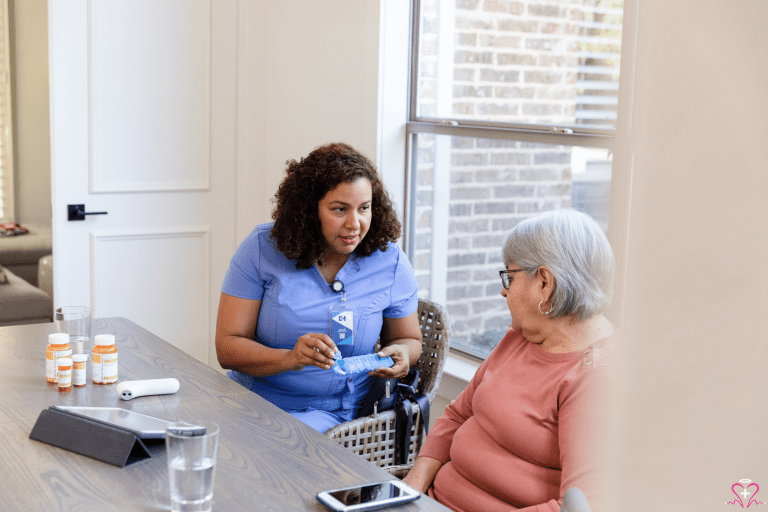 The Importance of Regular Medication Reviews - A nurse in blue scrubs discussing medication with an elderly woman sitting at a table.