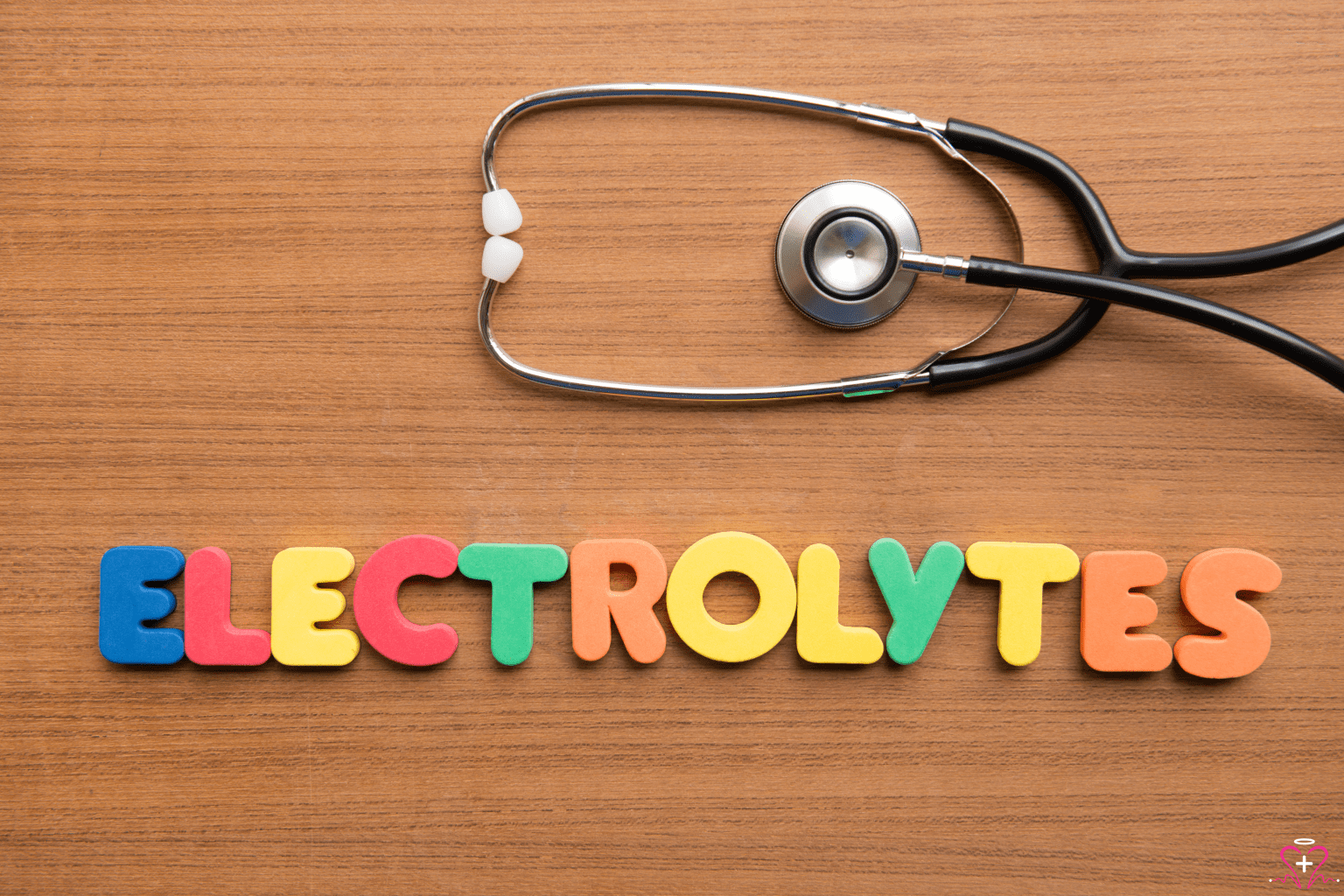 Electrolyte Panel - A stethoscope on a wooden surface with colorful letters spelling out "ELECTROLYTES," indicating the focus on electrolyte balance in the body.