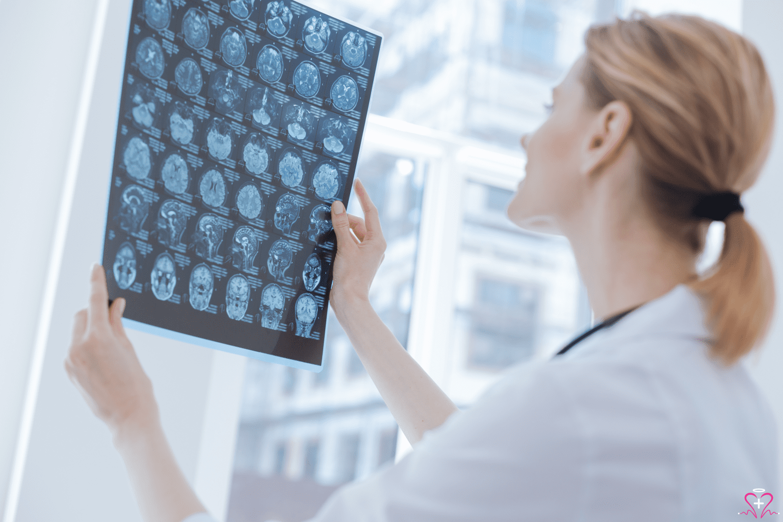 neurology: Neurologist examining brain scans on an X-ray film