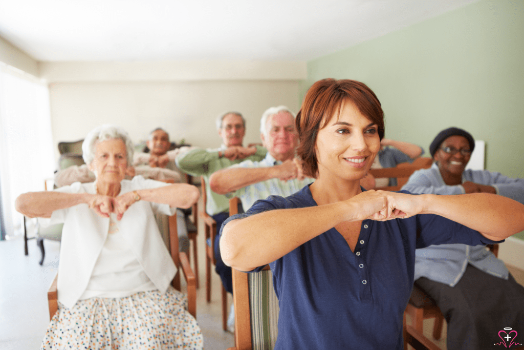 Group of seniors participating in a seated exercise class led by an instructor.