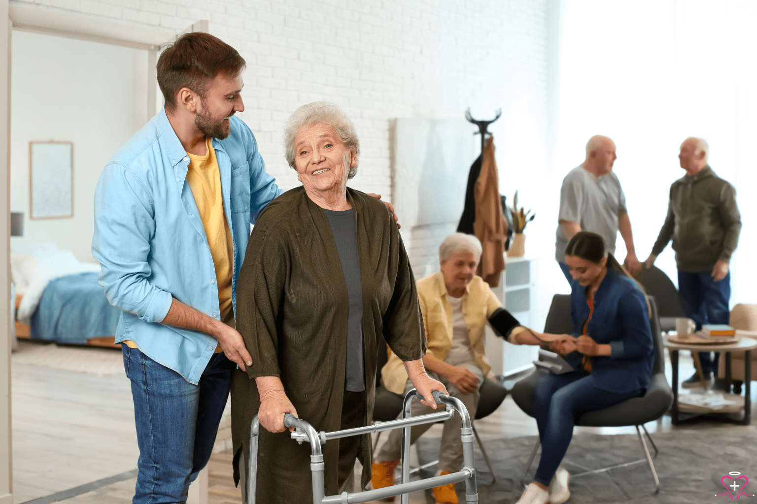 Understanding the Importance of Geriatric Psychiatry - A young man assisting an elderly woman with a walker in a community living space, with other seniors receiving various forms of care in the background.