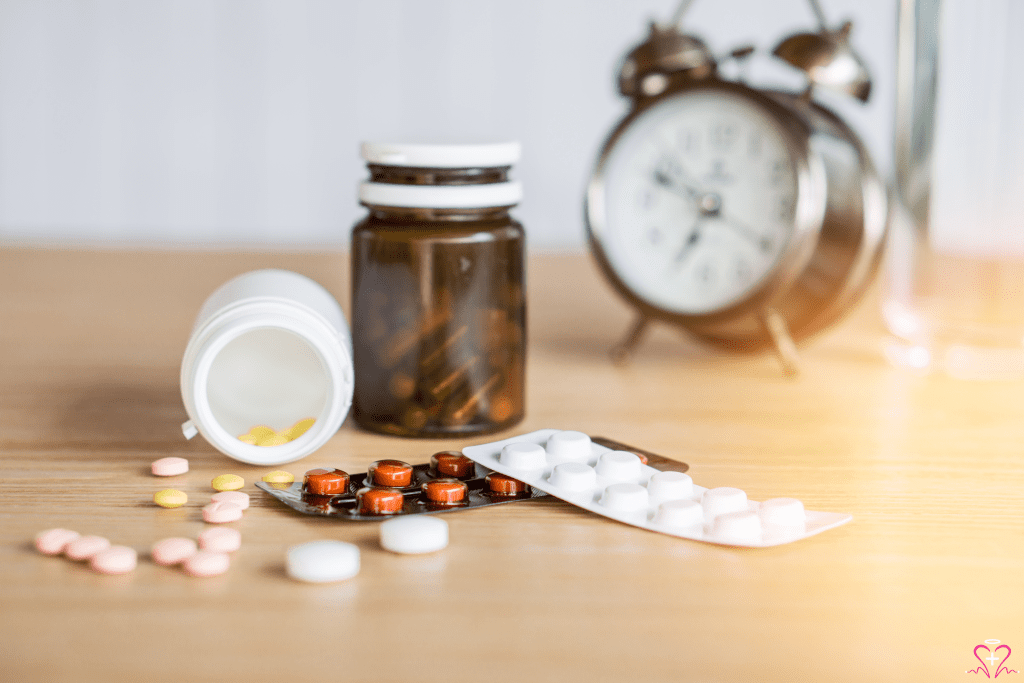 Medication Management - Various medications, including pills and blister packs, with an alarm clock in the background.