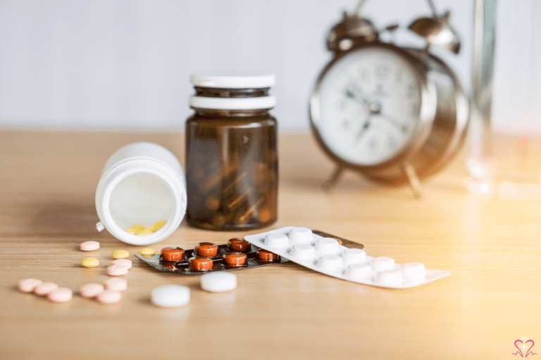 Medication Management - Various medications, including pills and blister packs, with an alarm clock in the background.