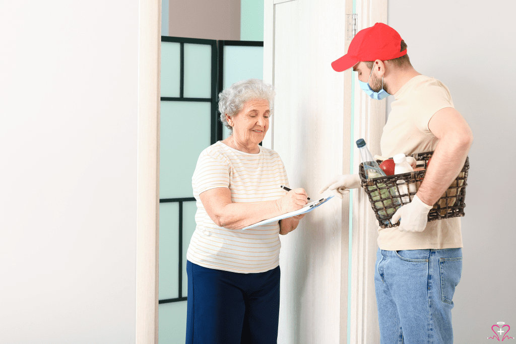 Free Meal Delivery Services - Elderly woman signing for grocery delivery from masked worker