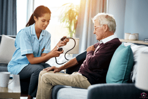 Importance of Regular Blood Pressure Screenings - A healthcare worker measuring the blood pressure of an elderly man in a home setting.