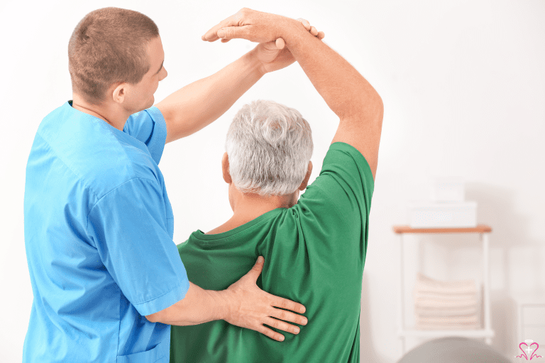 Physical Rehabilitation - A physical therapist assisting an elderly man with arm and shoulder exercises.