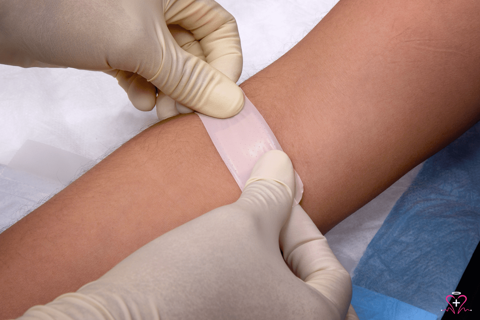 A professional phlebotomist applying a bandage to a patient's arm after a blood draw, illustrating the convenience and care provided by mobile phlebotomy services.