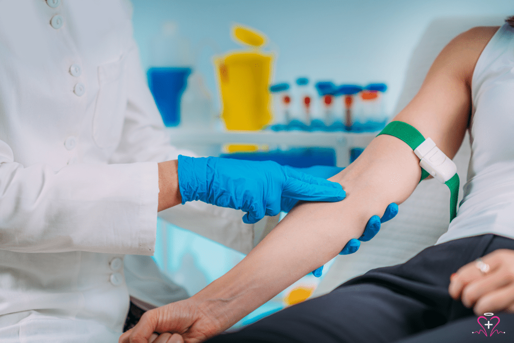 Mobile Phlebotomy Services - A phlebotomist in a white coat and blue gloves preparing to draw blood from a patient's arm using a green tourniquet.