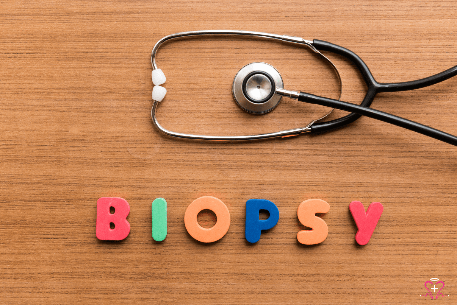 Biopsies - A stethoscope and colorful letters spelling "BIOPSY" on a wooden surface.