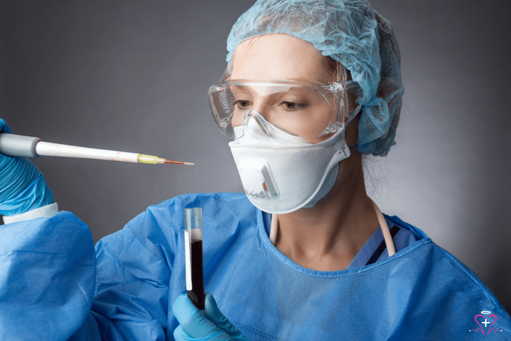 Pathologist - A pathologist wearing protective gear, including a mask, goggles, and surgical gown, handling a blood sample with a pipette.