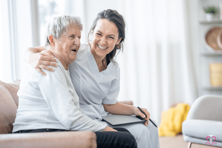 What is Protective Supervision? - Smiling nurse hugging a happy senior woman, both sitting on a couch.