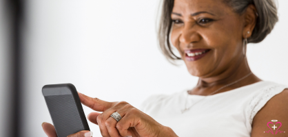 Smiling senior woman using a smartphone, representing digital engagement, communication, and the Senior Social Media Advocate job opportunity