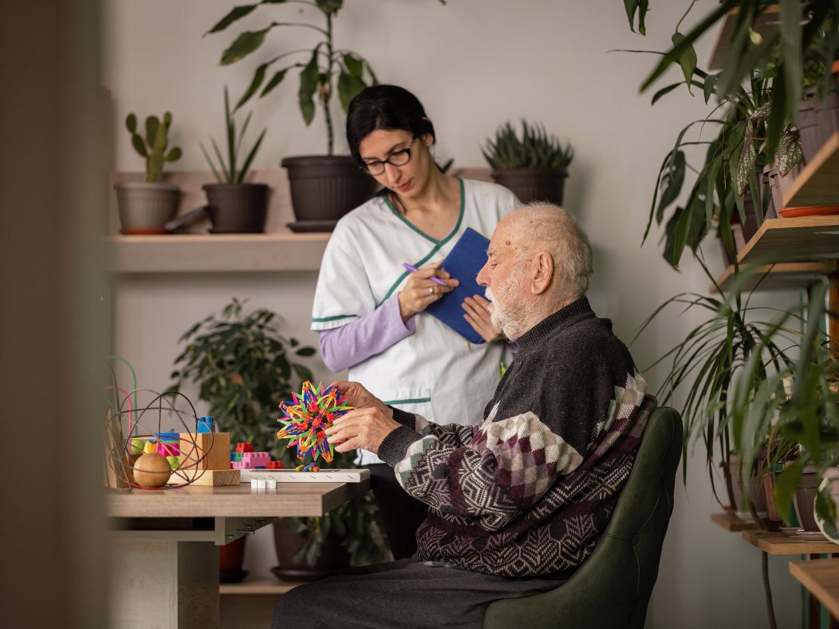 Home health nurse assisting elderly man with daily activities — All Seniors Foundation