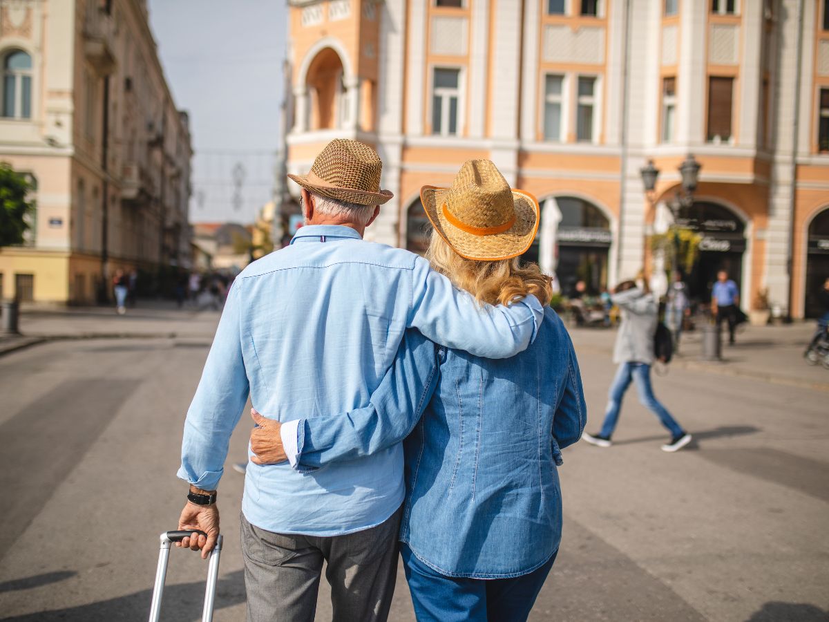 “Senior-Friendly Travel Destinations” – a smiling retired couple exploring an iconic city landmark on an unforgettable retirement adventure.