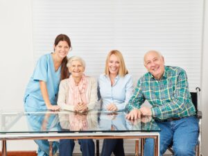 Smiling senior couple with caregiver – trusted senior placement services for families and caregivers in Los Angeles.