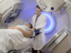 Doctor assisting a patient during radiation therapy – help with cancer treatment costs and transportation for seniors in Los Angeles.