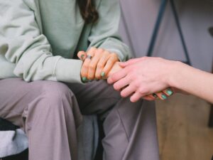 Therapist holding a patient’s hand – support and counseling for cancer patients promoting emotional healing and mental health for seniors.
