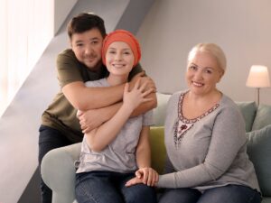 Smiling cancer survivor with supportive family – survivorship programs for seniors providing post-treatment care and emotional wellness.