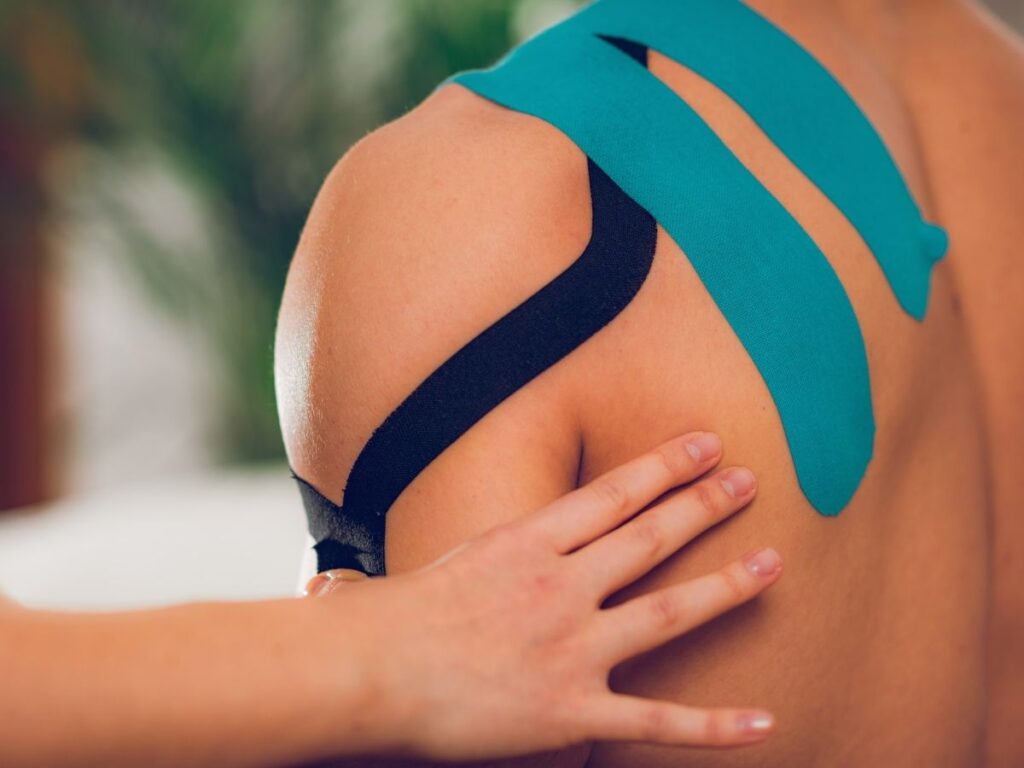 Physical therapist applying kinesiology tape for shoulder pain relief – shoulder pain treatment for seniors in Los Angeles.