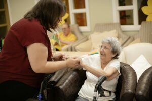Caregiver helping senior with walker, illustrating free mobility equipment for seniors in Los Angeles