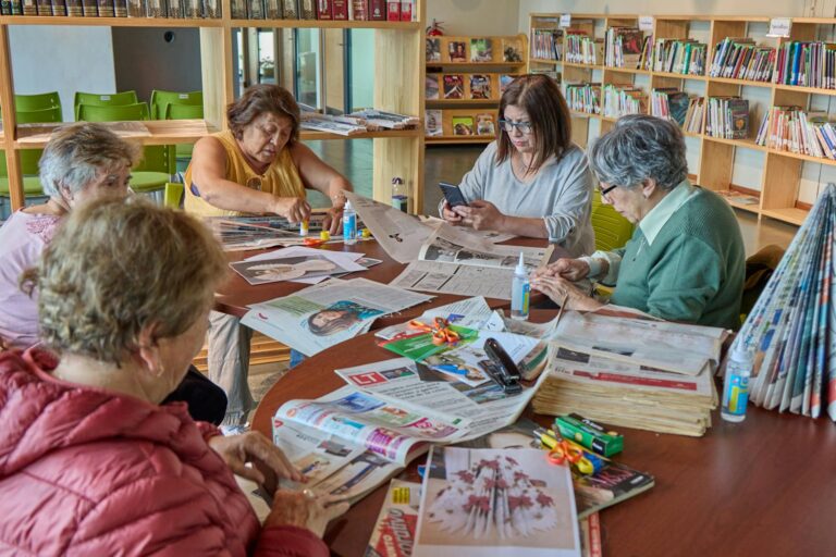 Community-center staff sharing senior-support resource information with older adults in Los Angeles.