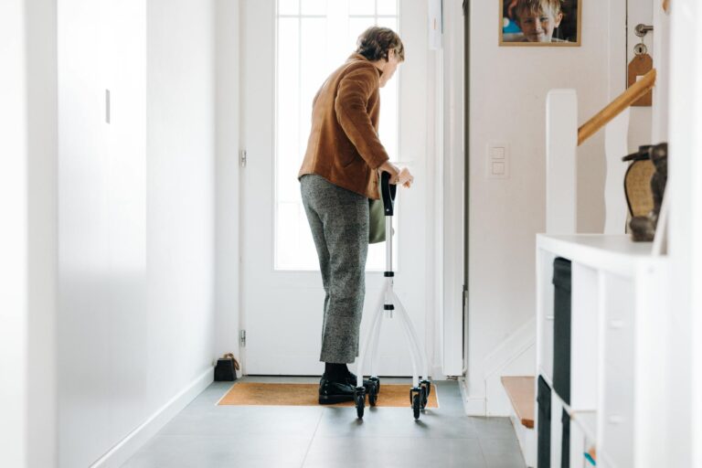 Senior adult using a rollator indoors, embracing mobility aid with confidence.