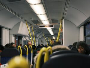 Passengers commuting inside a modern public train during the day.