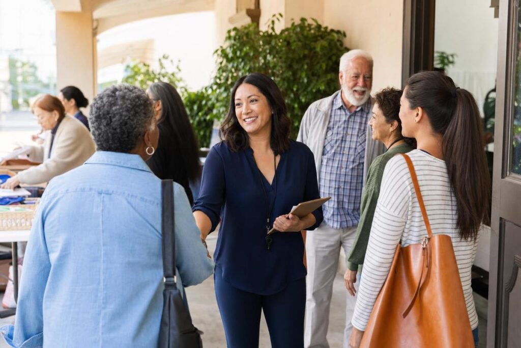 Volunteer engagement manager greeting community members for senior support outreach in Los Angeles