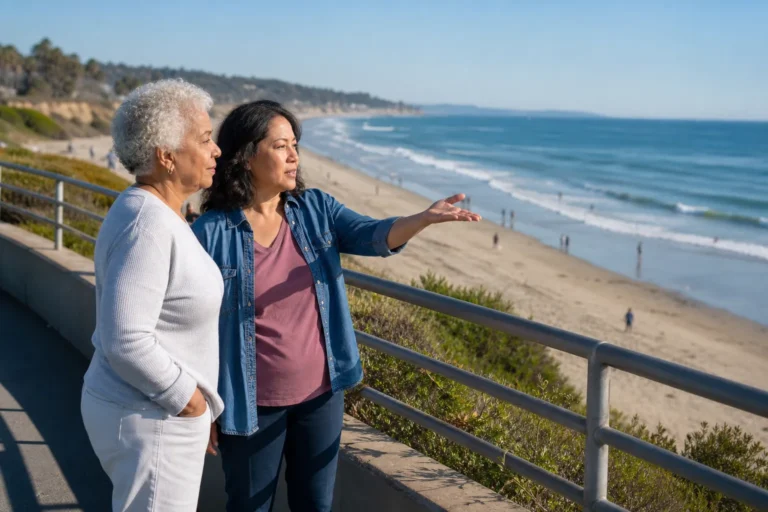 Older woman and family helper looking over a Los Angeles County beach before a visit